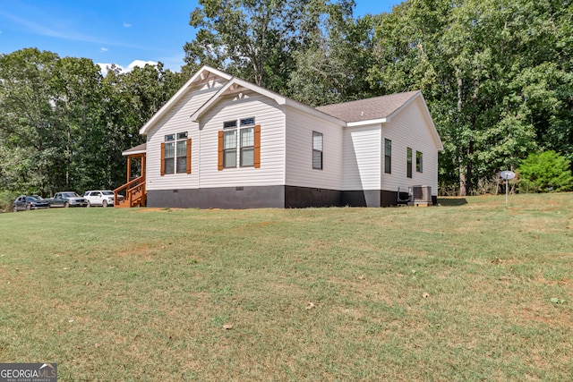 view of property exterior with cooling unit and a yard