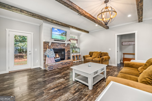 living room featuring ornamental molding, dark hardwood / wood-style floors, beam ceiling, an inviting chandelier, and a brick fireplace