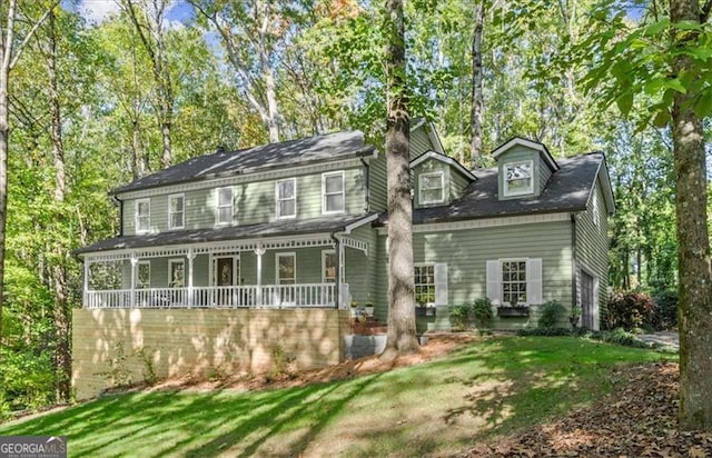 view of front of house featuring covered porch and a front lawn