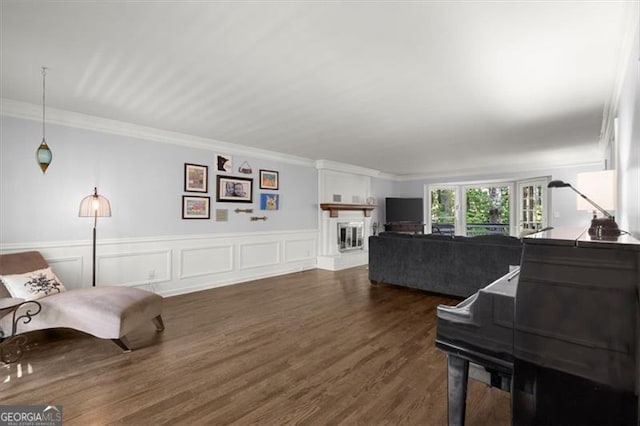 living room with dark hardwood / wood-style flooring and ornamental molding