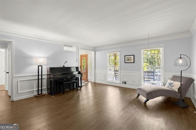 living area featuring ornamental molding and dark hardwood / wood-style floors