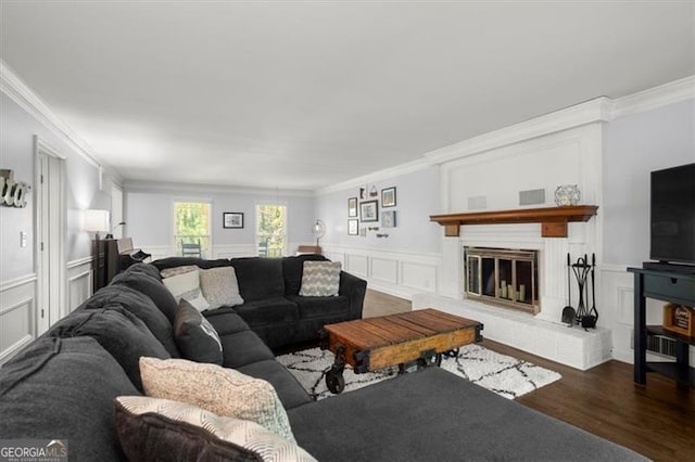 living room featuring ornamental molding and dark hardwood / wood-style flooring