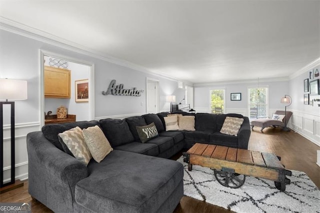 living room with dark hardwood / wood-style flooring and ornamental molding