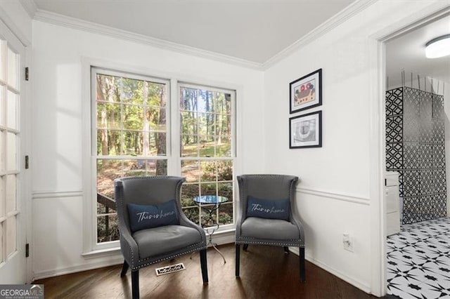 living area featuring crown molding and dark hardwood / wood-style flooring