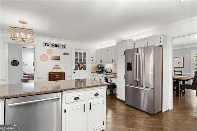 kitchen featuring white cabinetry, light stone counters, and stainless steel appliances