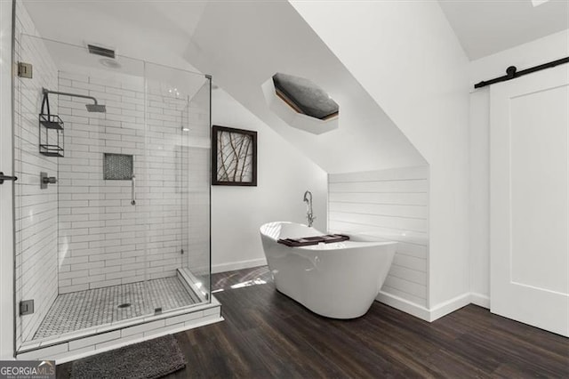 bathroom featuring hardwood / wood-style flooring and separate shower and tub