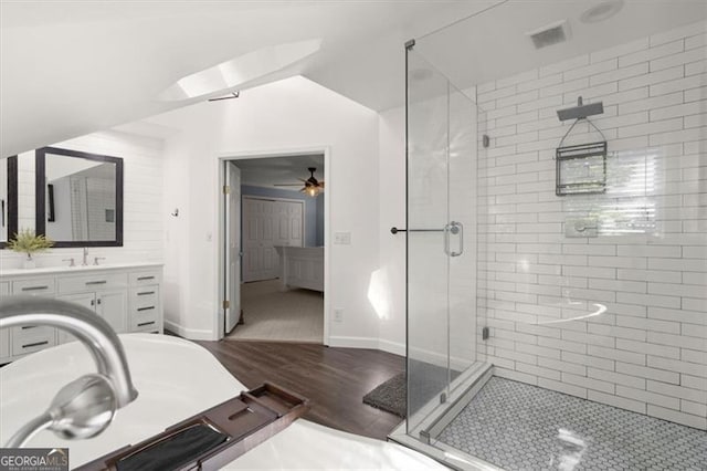 bathroom with ceiling fan, hardwood / wood-style flooring, a shower with door, and vanity