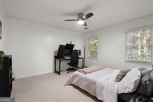 bedroom with crown molding, light carpet, multiple windows, and ceiling fan