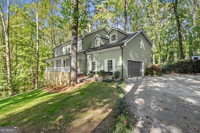 view of front of house with a garage and a front lawn