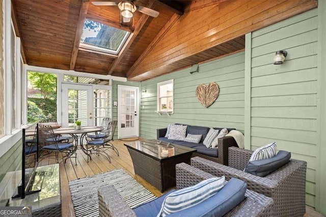 sunroom with ceiling fan, lofted ceiling with skylight, and wood ceiling