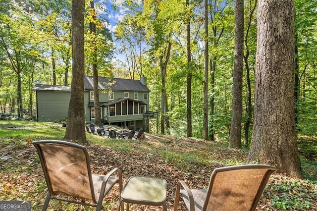 back of house featuring a sunroom