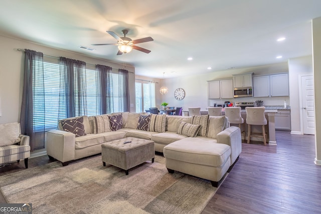 living room featuring ceiling fan and dark hardwood / wood-style flooring