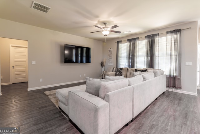 living room featuring dark hardwood / wood-style floors and ceiling fan