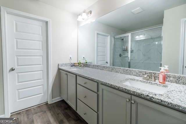 bathroom featuring a shower with door, vanity, and hardwood / wood-style floors