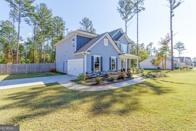 view of front of property featuring a front yard and a garage