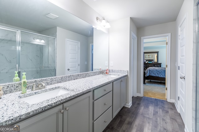 bathroom featuring vanity, hardwood / wood-style floors, and a shower with shower door