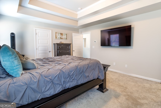 bedroom featuring crown molding, carpet flooring, and a tray ceiling