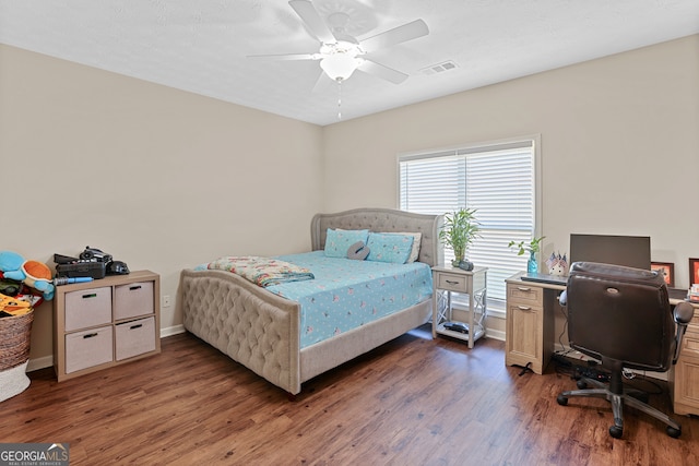 bedroom with ceiling fan and dark hardwood / wood-style floors