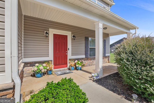 doorway to property featuring covered porch