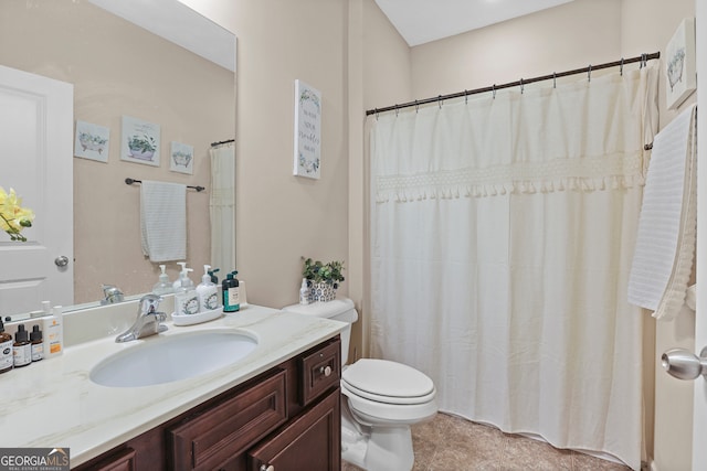 bathroom featuring vanity, curtained shower, and toilet