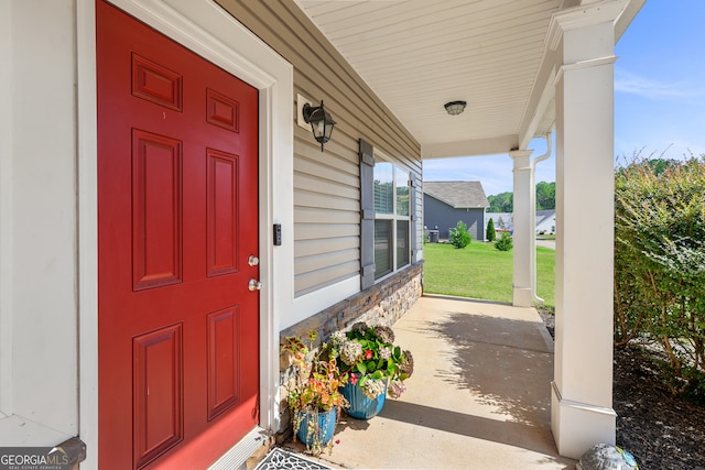 view of exterior entry featuring a porch