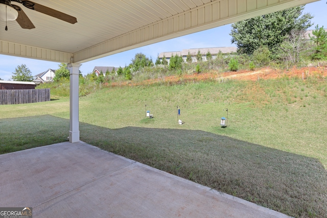 view of yard featuring ceiling fan and a patio area