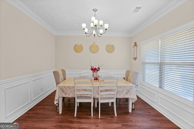 dining room with ornamental molding, a chandelier, and dark hardwood / wood-style floors