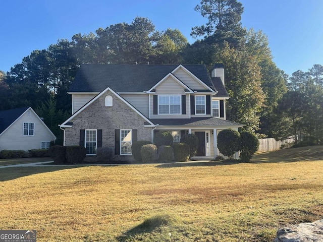 front facade featuring covered porch and a front yard