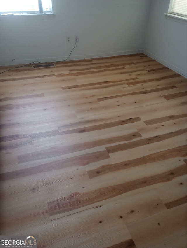 unfurnished room featuring light hardwood / wood-style floors