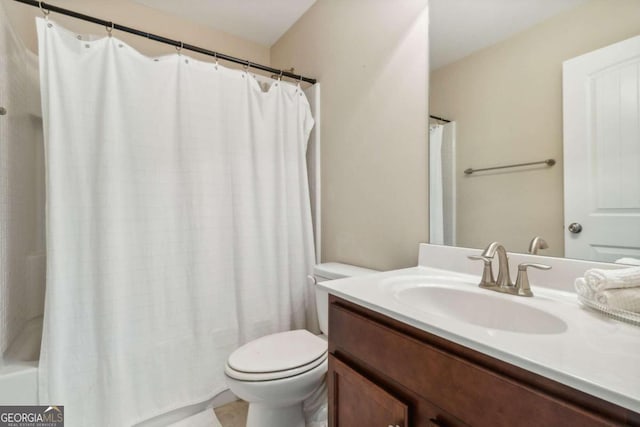 full bathroom with vanity, shower / bath combo, and toilet