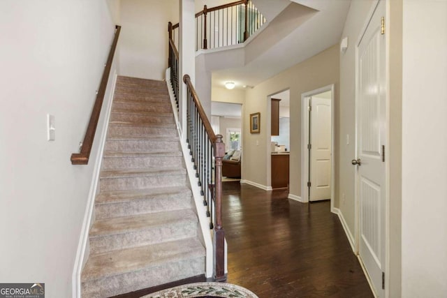 stairs featuring hardwood / wood-style floors