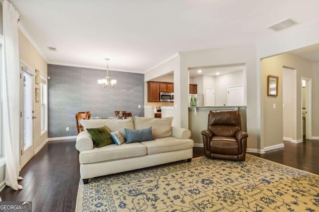 living room featuring crown molding, dark wood-type flooring, and a notable chandelier