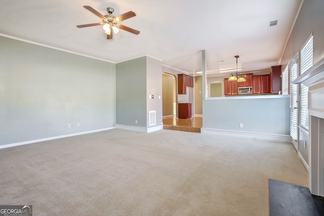 unfurnished living room featuring ornamental molding, ceiling fan, and carpet floors