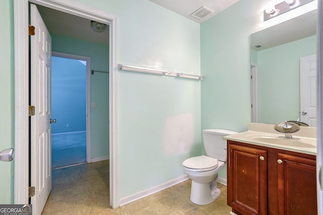 bathroom featuring toilet and vanity