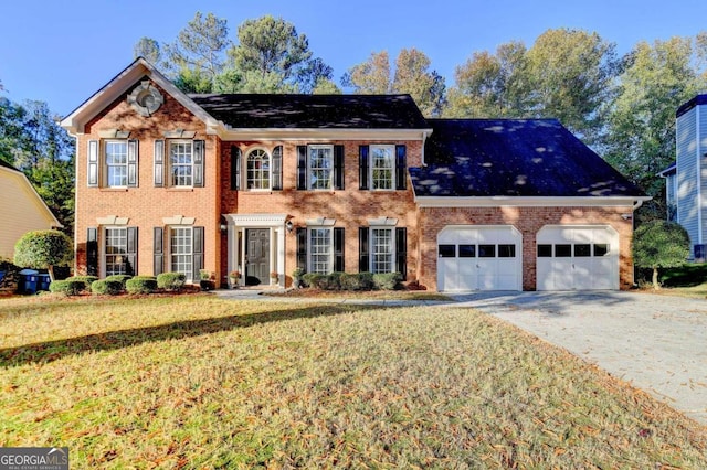 colonial home with a front yard and a garage