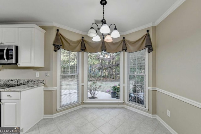 unfurnished dining area with an inviting chandelier and crown molding