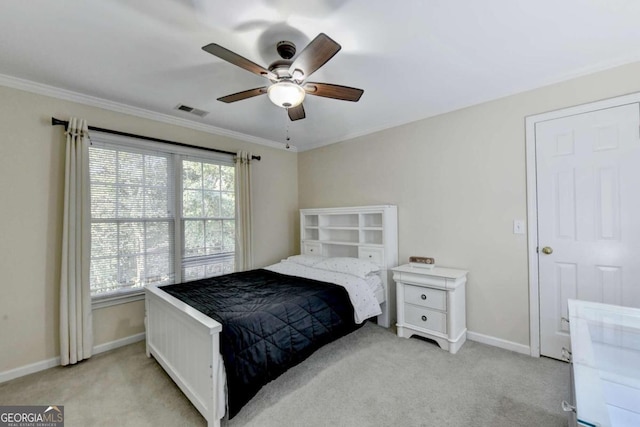 bedroom with crown molding, light colored carpet, and ceiling fan