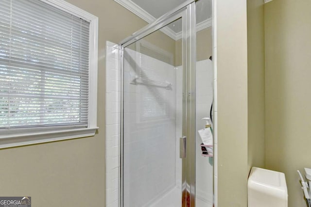 bathroom with vanity, ornamental molding, a shower with shower door, and toilet