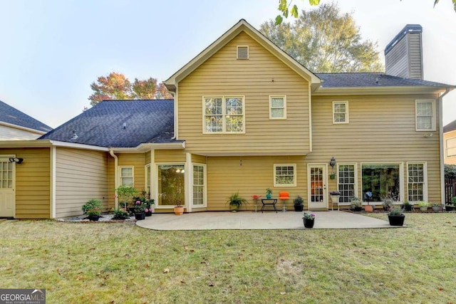 3034 Brookgreen Trl, Lawrenceville, GA 30043 - back of property featuring a yard, a chimney, a shingled roof, and a patio area
