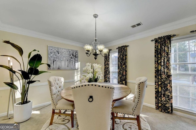 carpeted dining room featuring ornamental molding and a chandelier