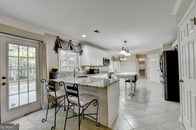 3034 Brookgreen Trl, Lawrenceville, GA 30043 - kitchen with visible vents, ornamental molding, a peninsula, a sink, and stainless steel appliances