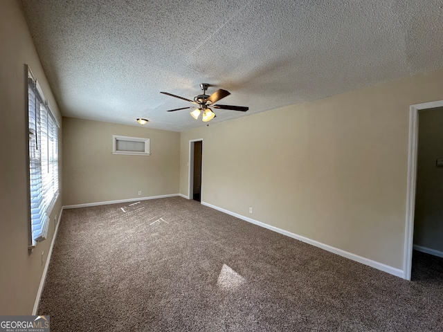 carpeted spare room featuring a textured ceiling and ceiling fan