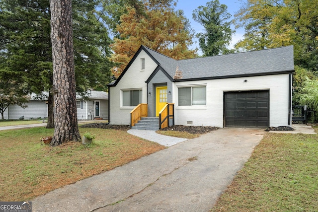 view of front of property featuring a garage and a front lawn