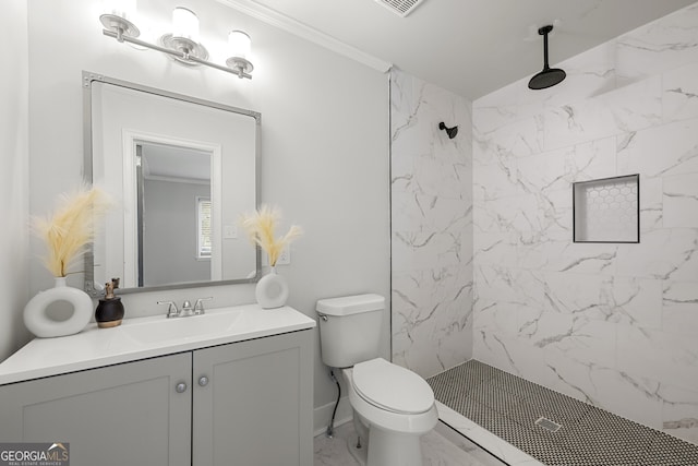 bathroom featuring vanity, toilet, tiled shower, and crown molding