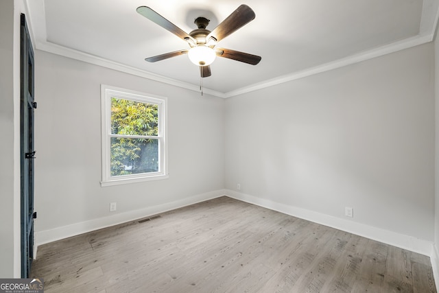 empty room with ceiling fan, crown molding, and light hardwood / wood-style flooring