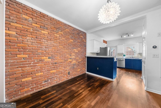 kitchen featuring white cabinetry, blue cabinetry, brick wall, and dark wood-type flooring