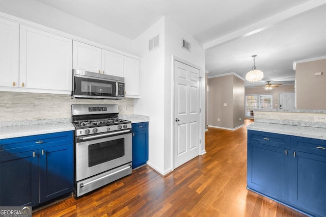 kitchen with dark hardwood / wood-style floors, blue cabinets, stainless steel appliances, and backsplash