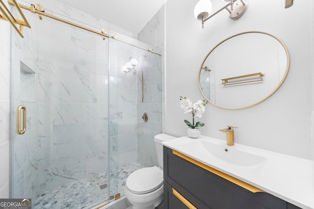 bathroom featuring vanity, toilet, and an enclosed shower