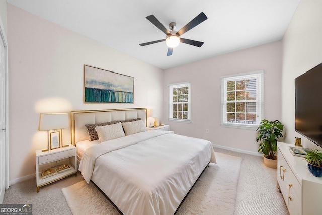 bedroom featuring light carpet and ceiling fan