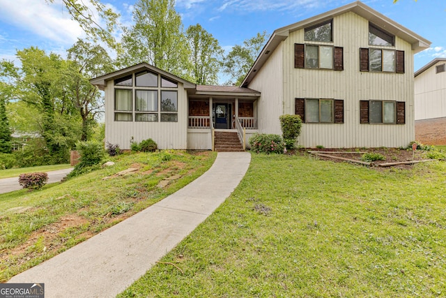 view of front of property with covered porch and a front lawn